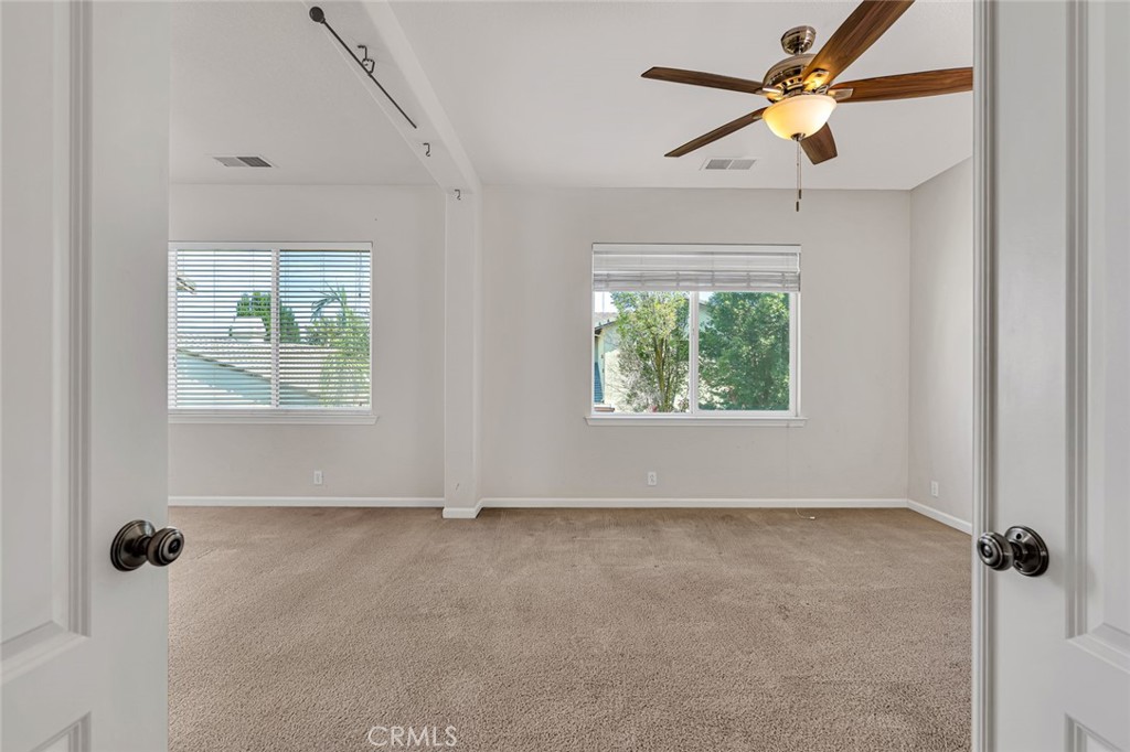 1289 Verdon Court Merced, CA 95348 - Photo 39 of 56 an empty room with windows and fan