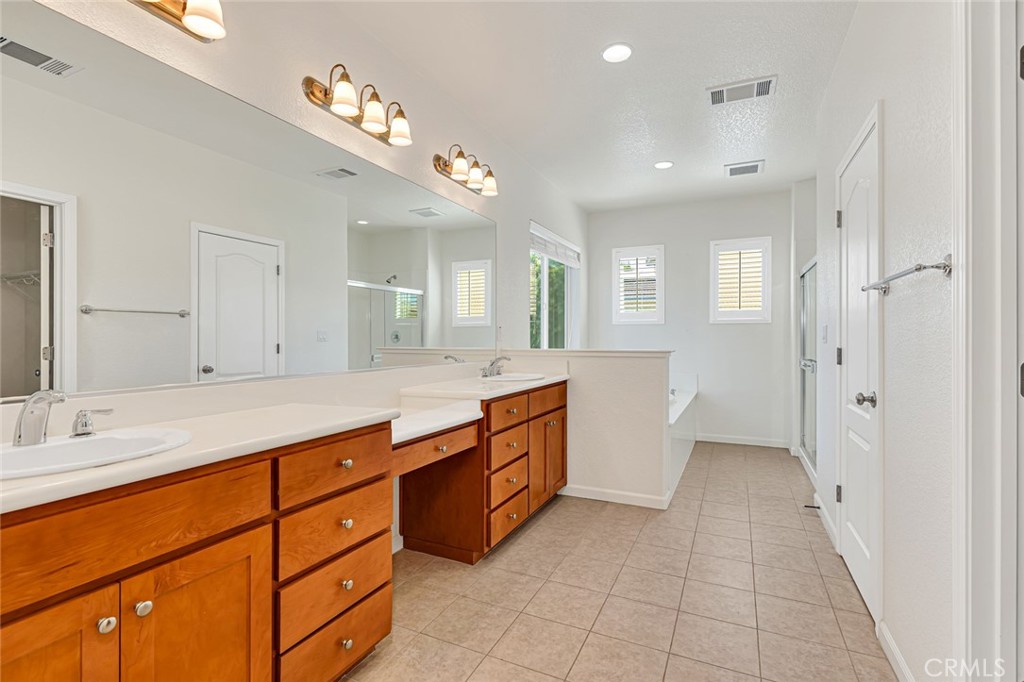 1289 Verdon Court Merced, CA 95348 - Photo 44 of 56 a spacious bathroom with a granite countertop sink mirror and shower