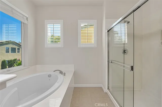 a view of backyard with a tub and wooden fence
