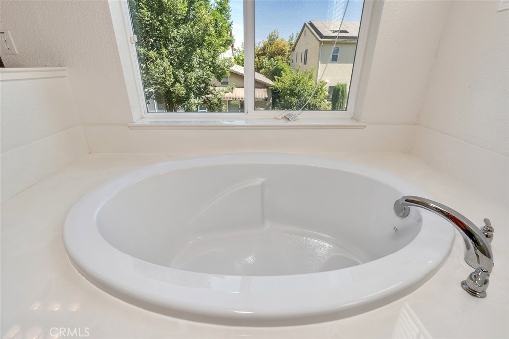 1289 Verdon Court Merced, CA 95348 - Photo 49 of 56 a white bath tub sitting in a bathroom