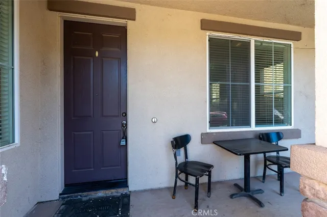 a view of a livingroom with furniture and a window