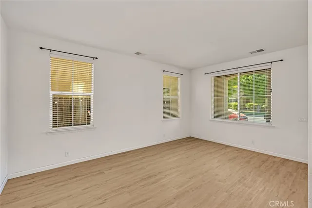 a room with pool table and windows