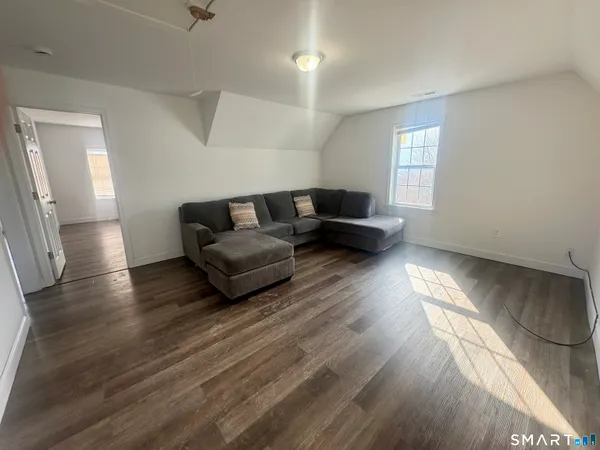 a living room with furniture and a hard wood floor