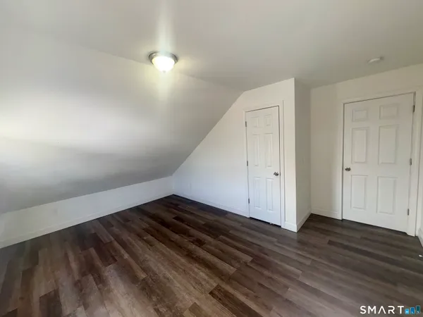 a view of an empty room and wooden floor