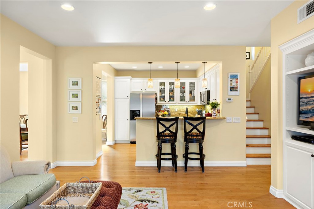 8 Earthen Court Ladera Ranch, CA 92694 - Photo 14 of 58 a living room with dining room and wooden floor