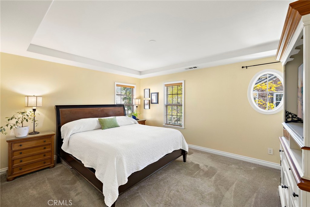8 Earthen Court Ladera Ranch, CA 92694 - Photo 17 of 58 a bedroom with a bed and a lamp on the dresser