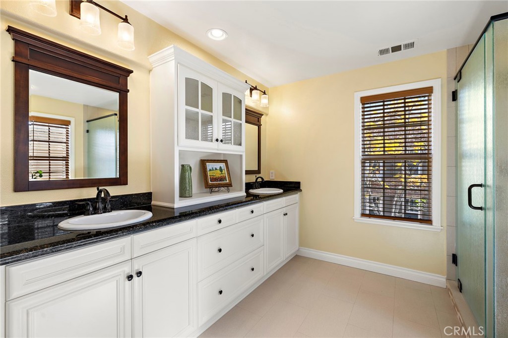 8 Earthen Court Ladera Ranch, CA 92694 - Photo 21 of 58 a bathroom with double vanity and a mirror