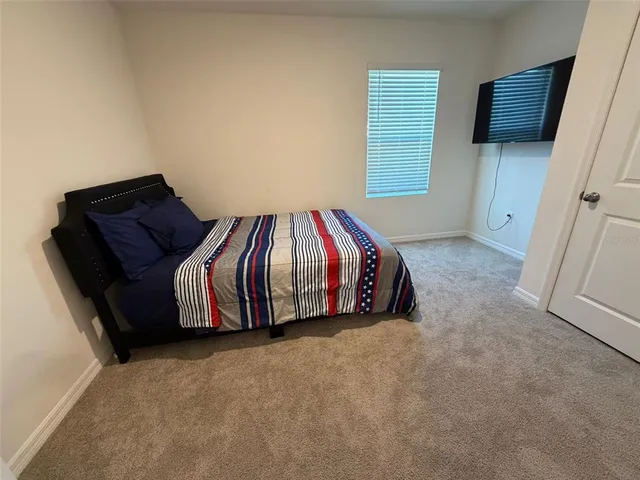 a bedroom with a bed and window