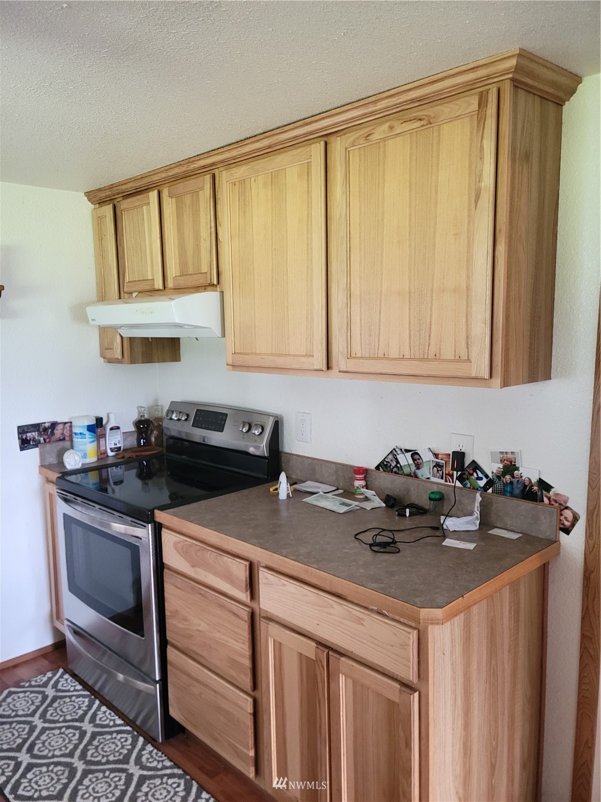 231 Monroe Road Winlock, WA 98596 - Photo 11 of 24 a kitchen with a stove a sink and cabinets