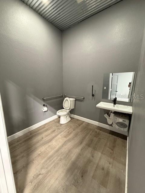 2130 West King Street Cocoa, FL 32926 - Photo 9 of 20 a bathroom with a sink a toilet and a mirror