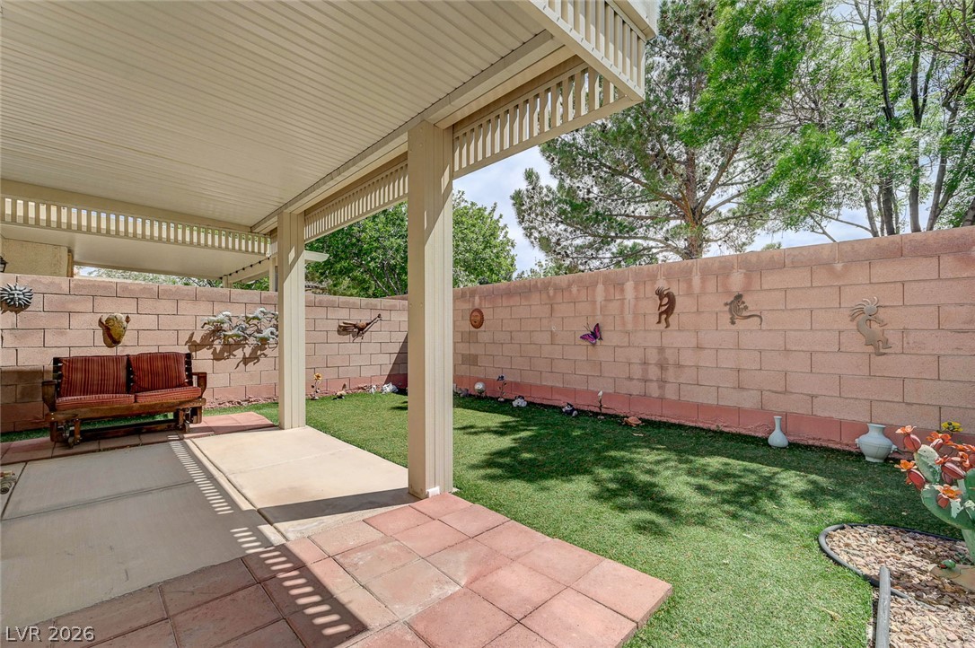 1479 Orange Jubilee Road Henderson, NV 89014 - Photo 34 of 36 A private backyard oasis features a shaded patio area and artificial turf for tranquil outdoor living.