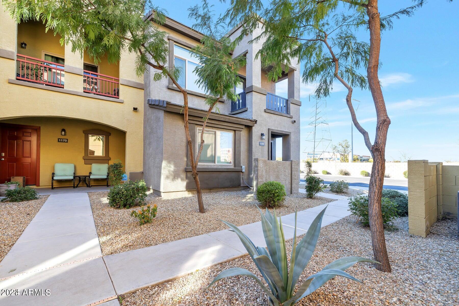 2150 West Alameda Road, Unit 1169 Phoenix, AZ 85085 - Photo 9 of 26 a front view of a house with garden