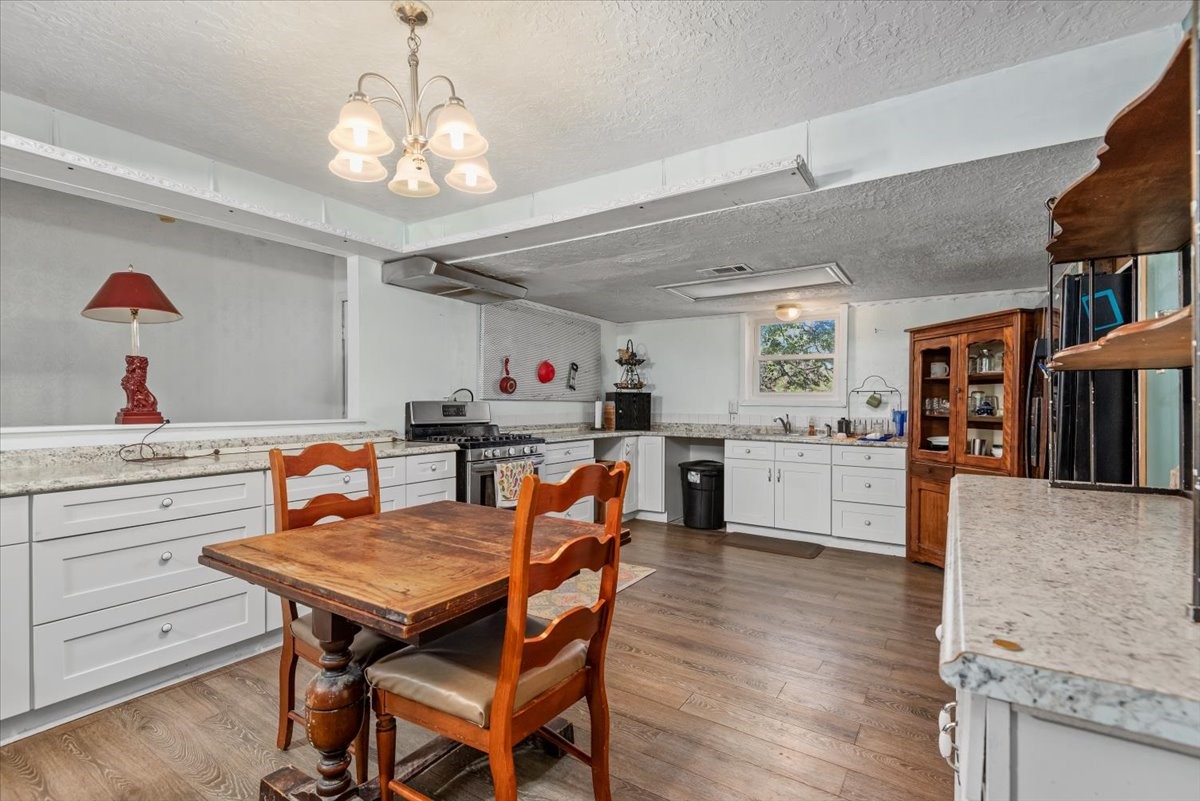 504 Catfish Lane Conroe, TX 77384 - Photo 12 of 48 a dining room with wooden floor and breakfast area