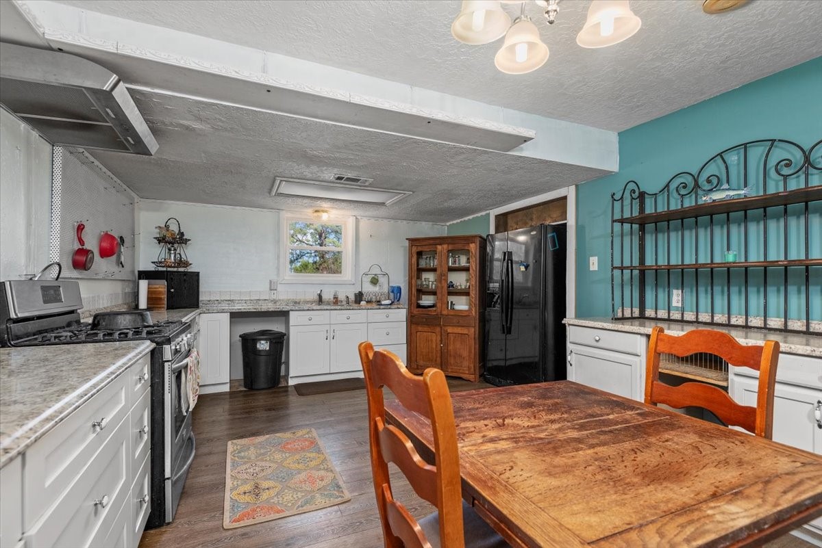 504 Catfish Lane Conroe, TX 77384 - Photo 13 of 48 a kitchen with a refrigerator and a stove