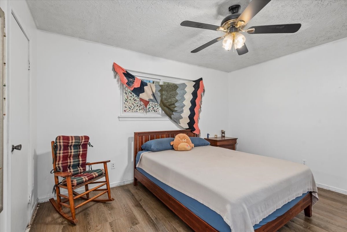 504 Catfish Lane Conroe, TX 77384 - Photo 17 of 48 a bedroom with a bed and a chandelier