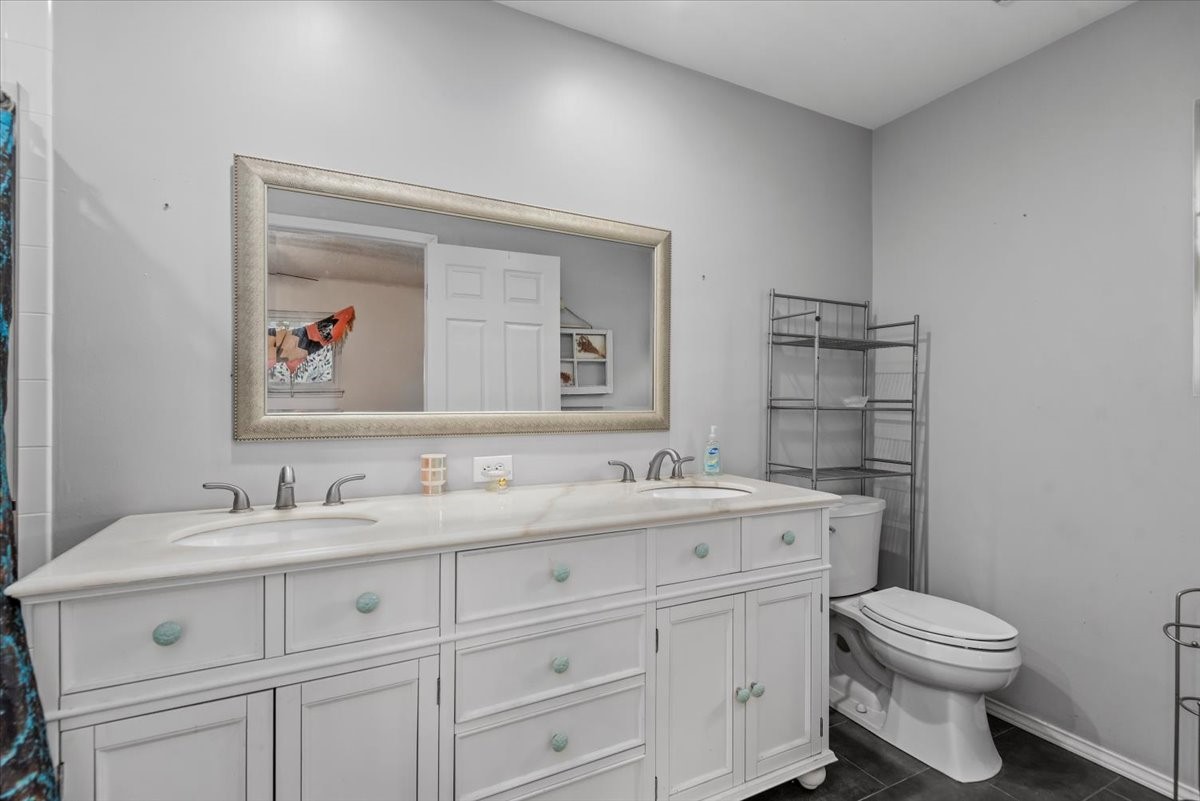 504 Catfish Lane Conroe, TX 77384 - Photo 19 of 48 a bathroom with a toilet a sink and mirror
