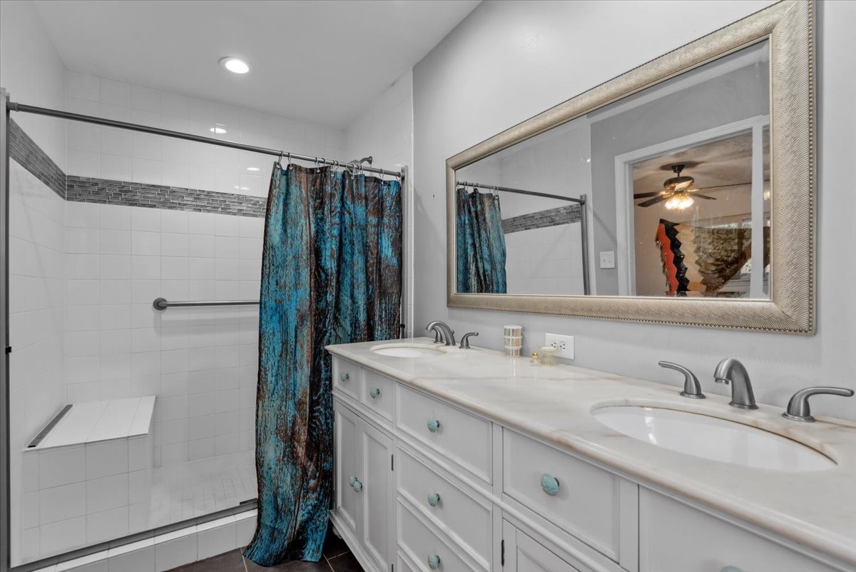 504 Catfish Lane Conroe, TX 77384 - Photo 20 of 48 a bathroom with a granite countertop sink mirror shower and double