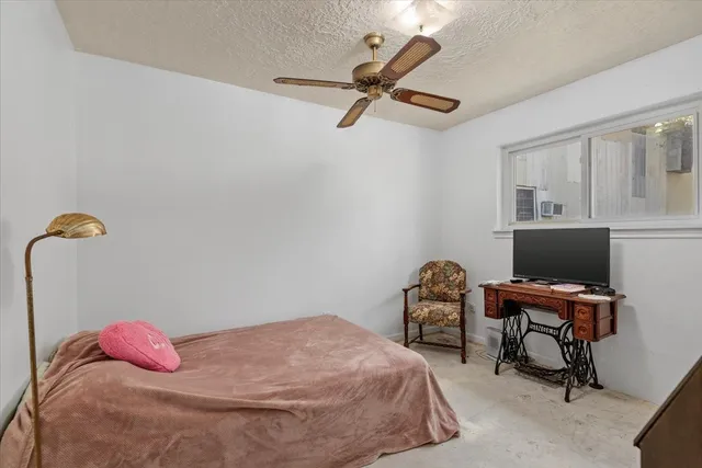 a bedroom with a bed and a chair