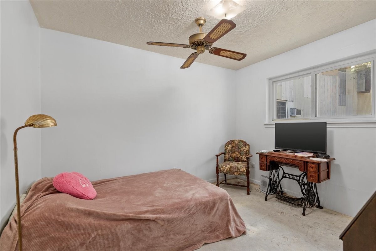 504 Catfish Lane Conroe, TX 77384 - Photo 23 of 48 a bedroom with a bed and a chair