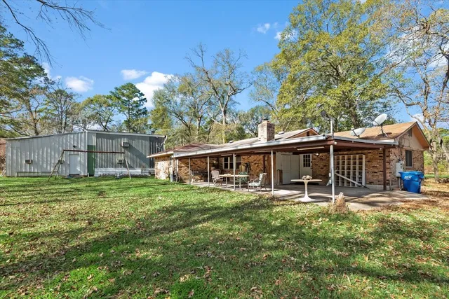 a view of a house with a yard and sitting area
