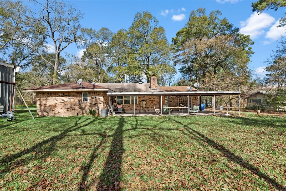 504 Catfish Lane Conroe, TX 77384 - Photo 31 of 48 a view of a house with a yard