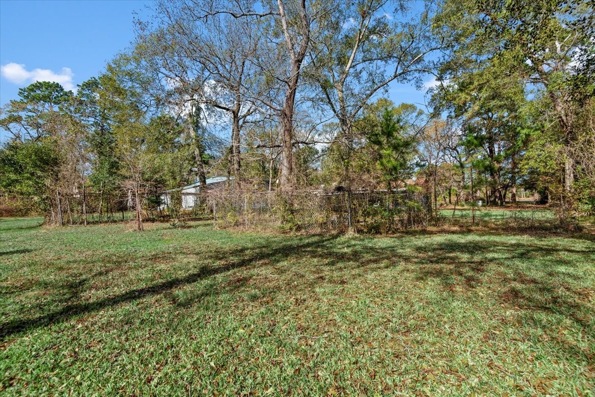504 Catfish Lane Conroe, TX 77384 - Photo 36 of 48 a view of outdoor space with trees all around