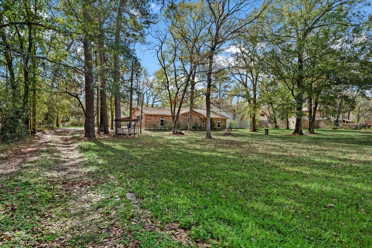 504 Catfish Lane Conroe, TX 77384 - Photo 5 of 48 a huge green field with lots of trees