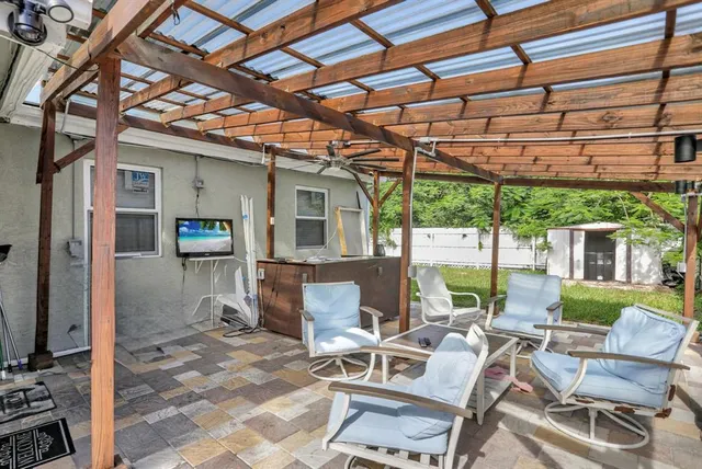 a building outdoor space with patio furniture and potted plants