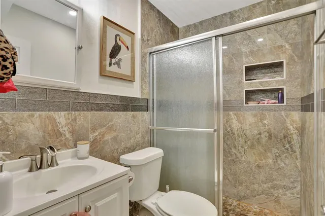 a bathroom with a sink toilet and shower