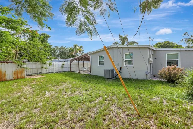 a view of a house with backyard and plants