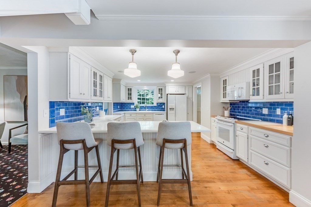 758 South Street Needham, MA 02492 - Photo 11 of 30 a kitchen with stainless steel appliances kitchen island granite countertop a table and chairs