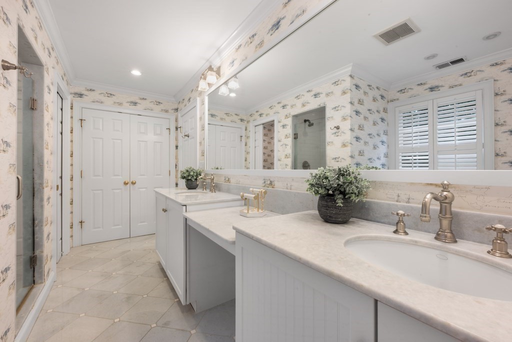 758 South Street Needham, MA 02492 - Photo 19 of 30 a bathroom with a sink double vanity mirror and shower