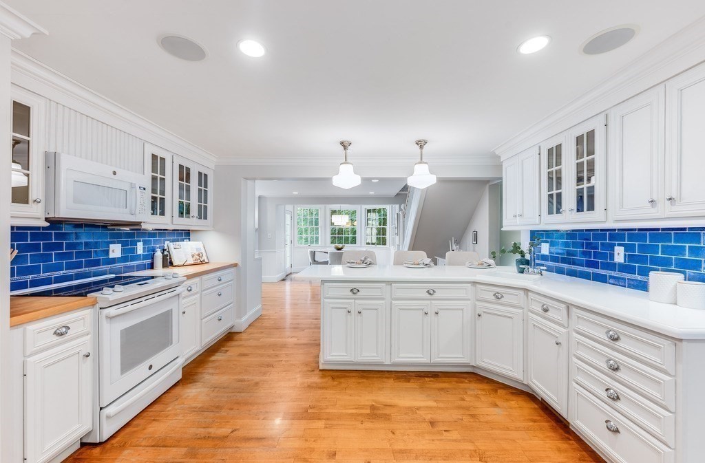 758 South Street Needham, MA 02492 - Photo 10 of 30 a large white kitchen with kitchen island a sink stainless steel appliances and cabinets