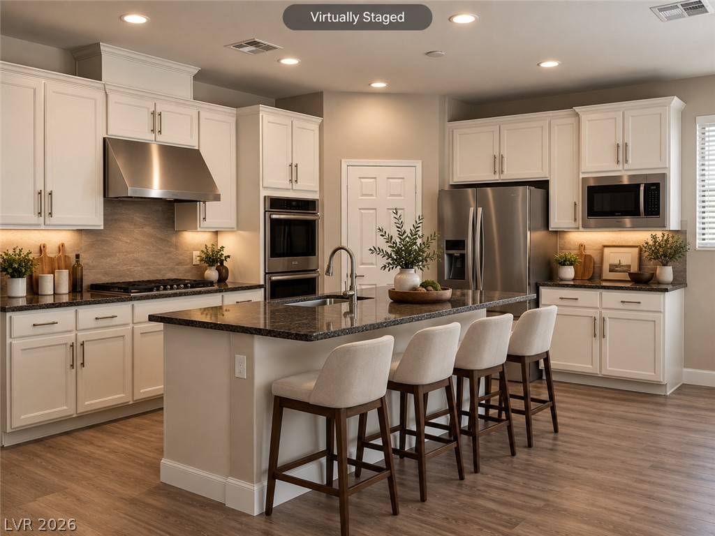 8059 Encanterra Road Las Vegas, NV 89113 - Photo 4 of 52 Polished stone countertops and seamless recessed lighting define this classic kitchen layout.