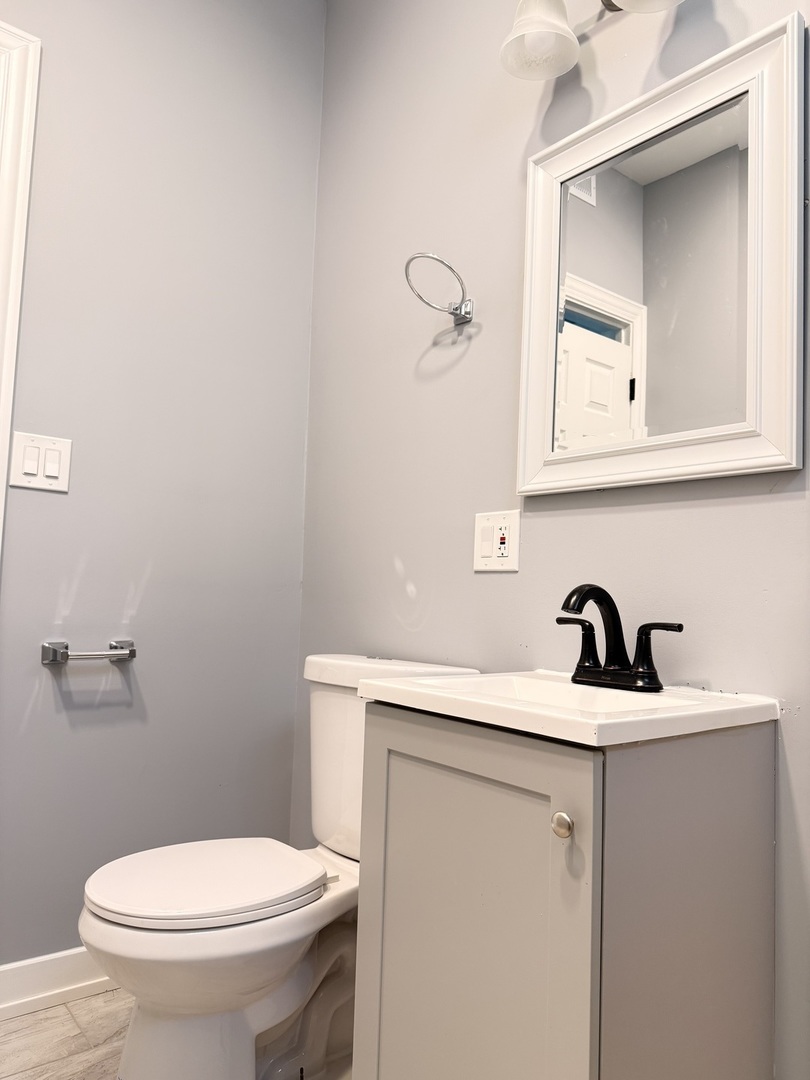 3821 West Fillmore Street, Unit 2R Chicago, IL 60624 - Photo 12 of 12 a bathroom with a sink a toilet and mirror