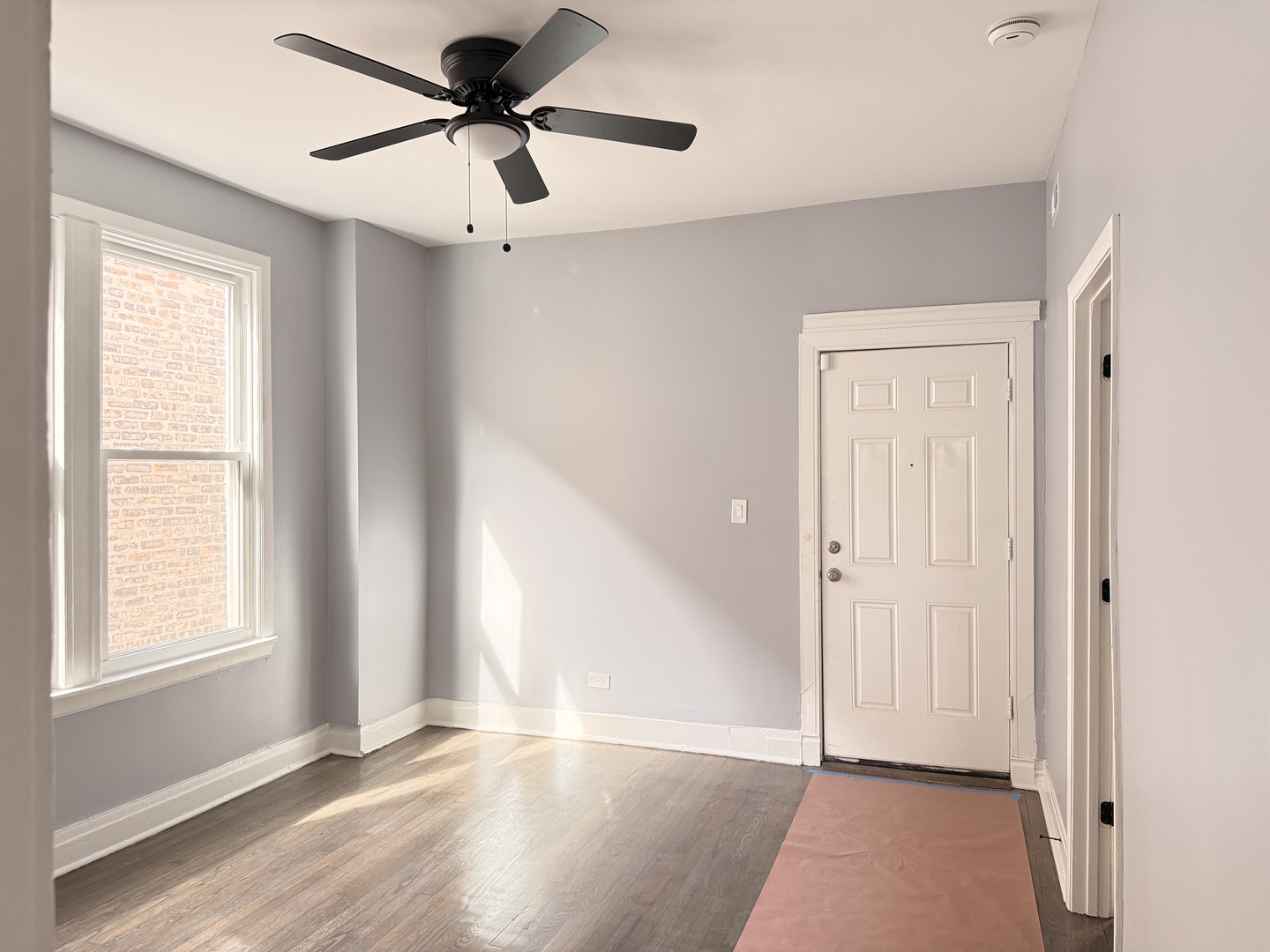 3821 West Fillmore Street, Unit 2R Chicago, IL 60624 - Photo 2 of 12 a view of a livingroom with a window and a ceiling fan