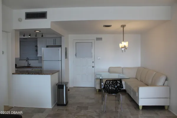 a living room with furniture and a chandelier