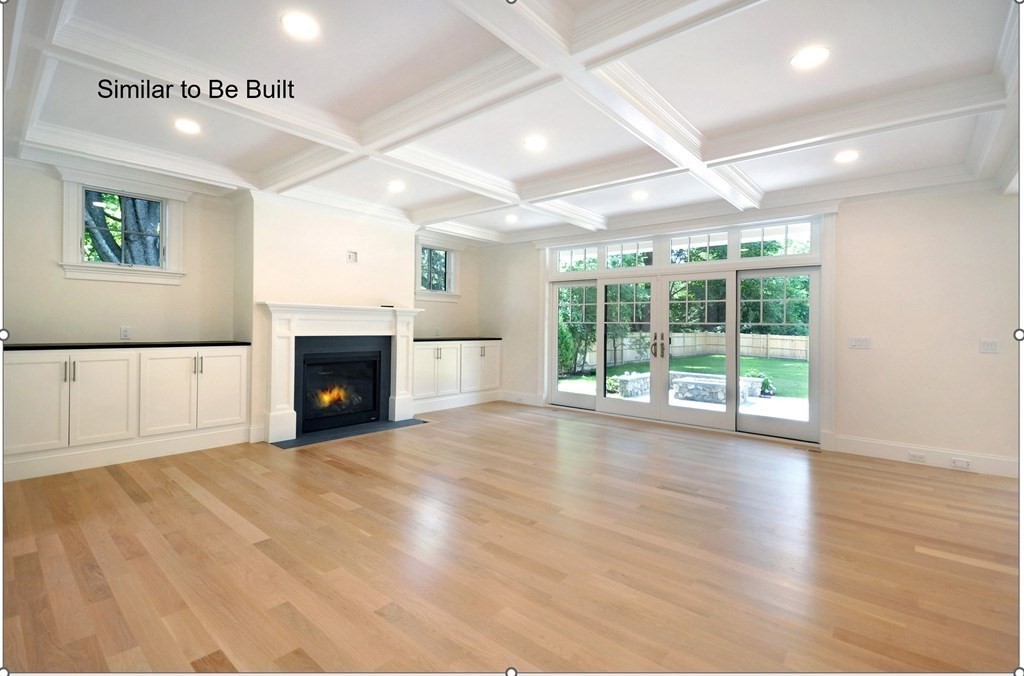 129 Shade Street Lexington, MA 02421 - Photo 3 of 6 a view of empty room with wooden floor and fireplace