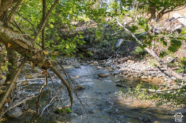 2855 East Canyon Road Richmond, UT 84333 - Photo 16 of 17 Natural stream featuring clear water and a rocky bed, surrounded by mature trees and lush foliage