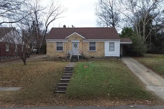 a front view of house with yard and trees