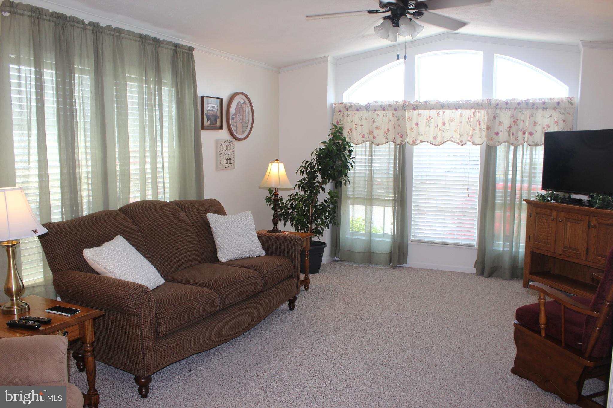 185 Rock Road, Unit 13 Ephrata, PA 17522 - Photo 3 of 24 a living room with furniture a chandelier and a flat screen tv