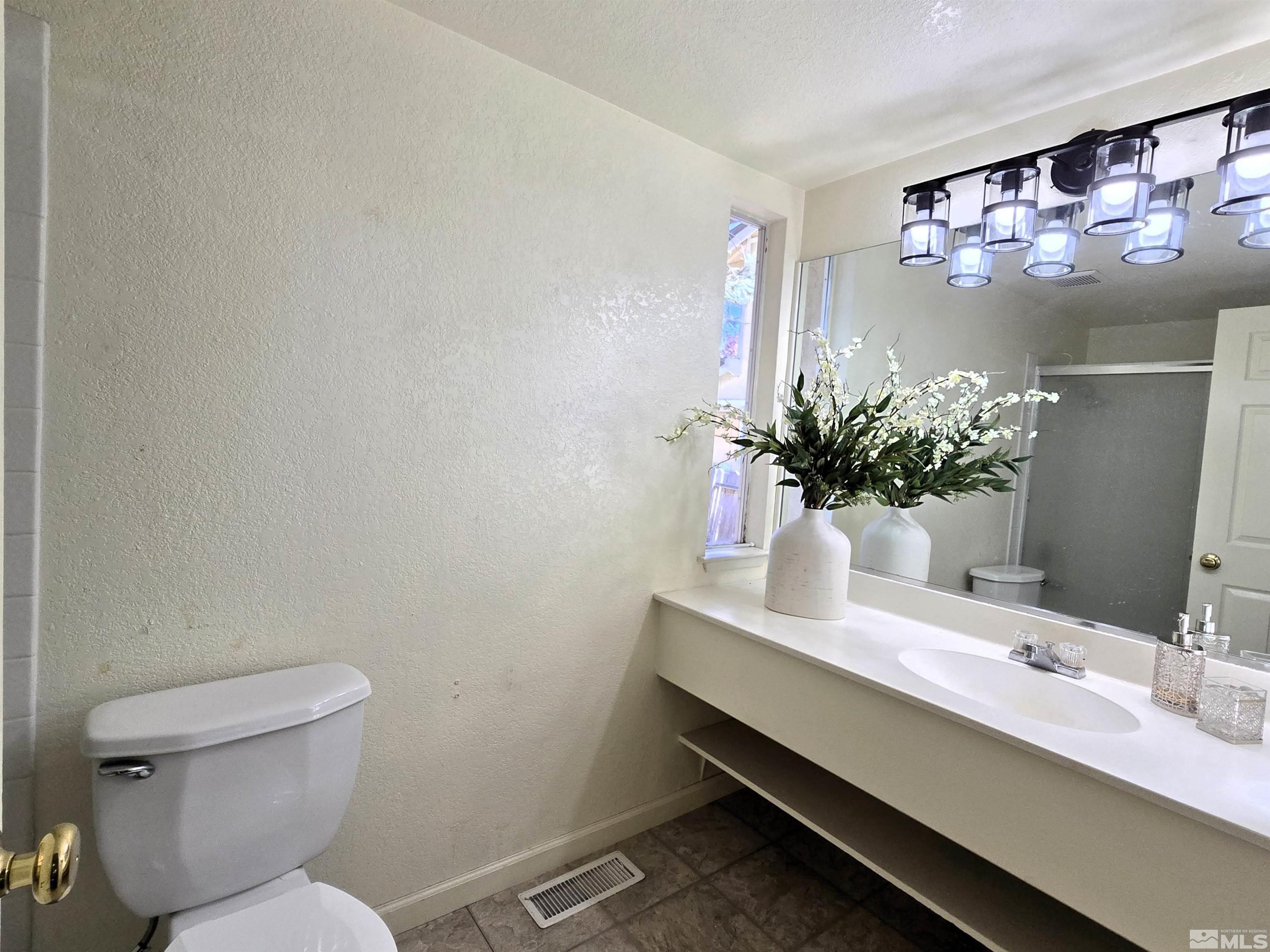 7030 Indigo Circle Reno, NV 89506 - Photo 16 of 22 a bathroom with a sink mirror and toilet