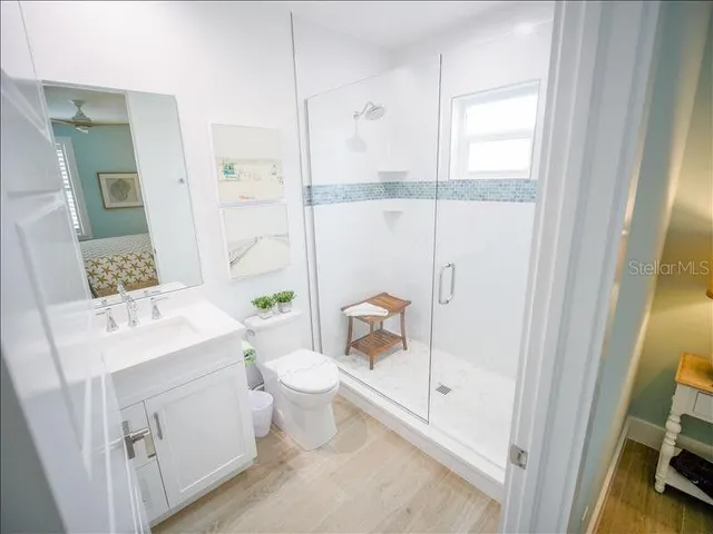a bathroom with a sink toilet and shower