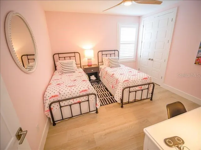 a bedroom with two beds and a window