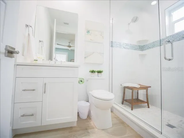 a bathroom with a toilet a sink and shower