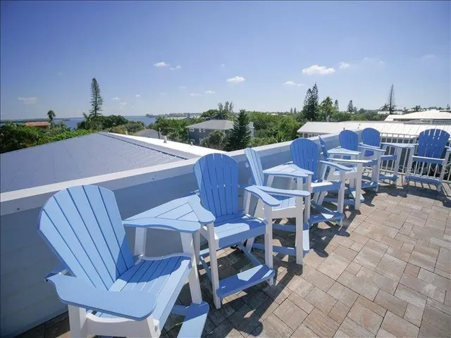 a view of a patio with table and chairs