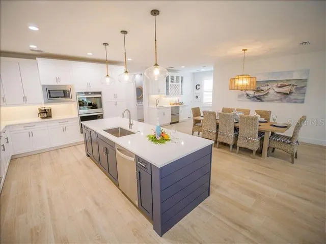 a kitchen that has a lot of cabinets in it