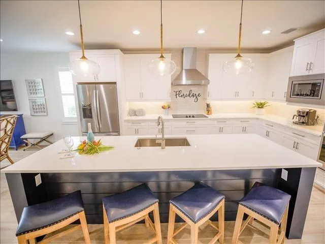 a large kitchen with a table and chairs