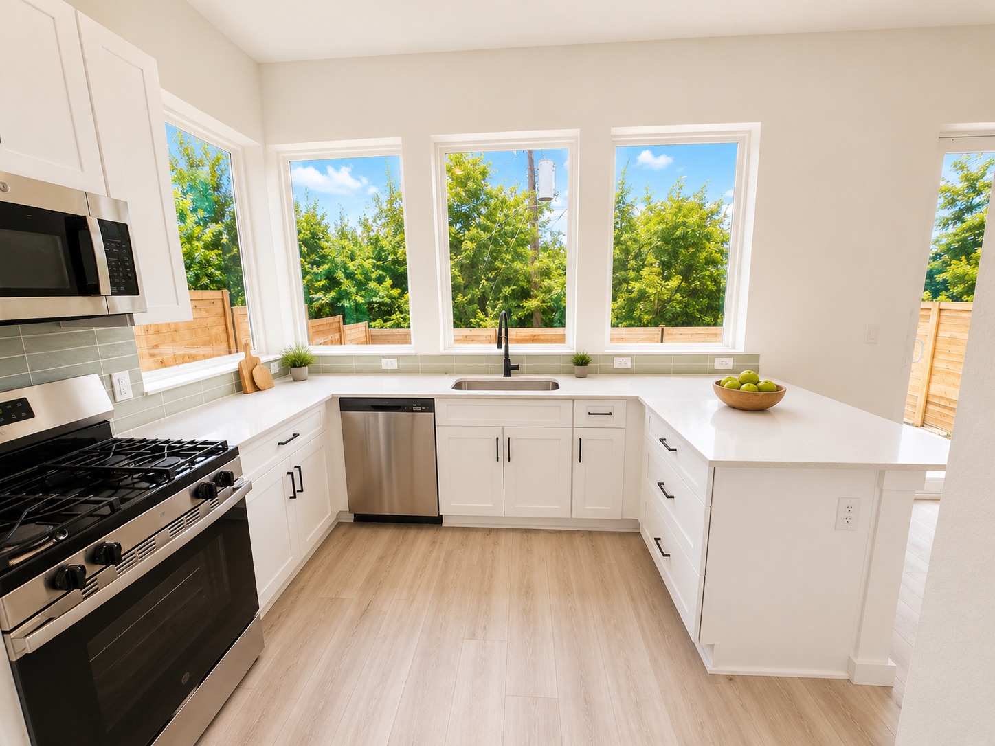 2000 Riverside Farms Road, Unit 6102 Austin, TX 78741 - Photo 3 of 11 A well-lit kitchen with sleek white cabinetry and resilient hardwood flooring beckons culinary adventures.