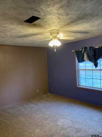 a view of a livingroom with an empty space and a window